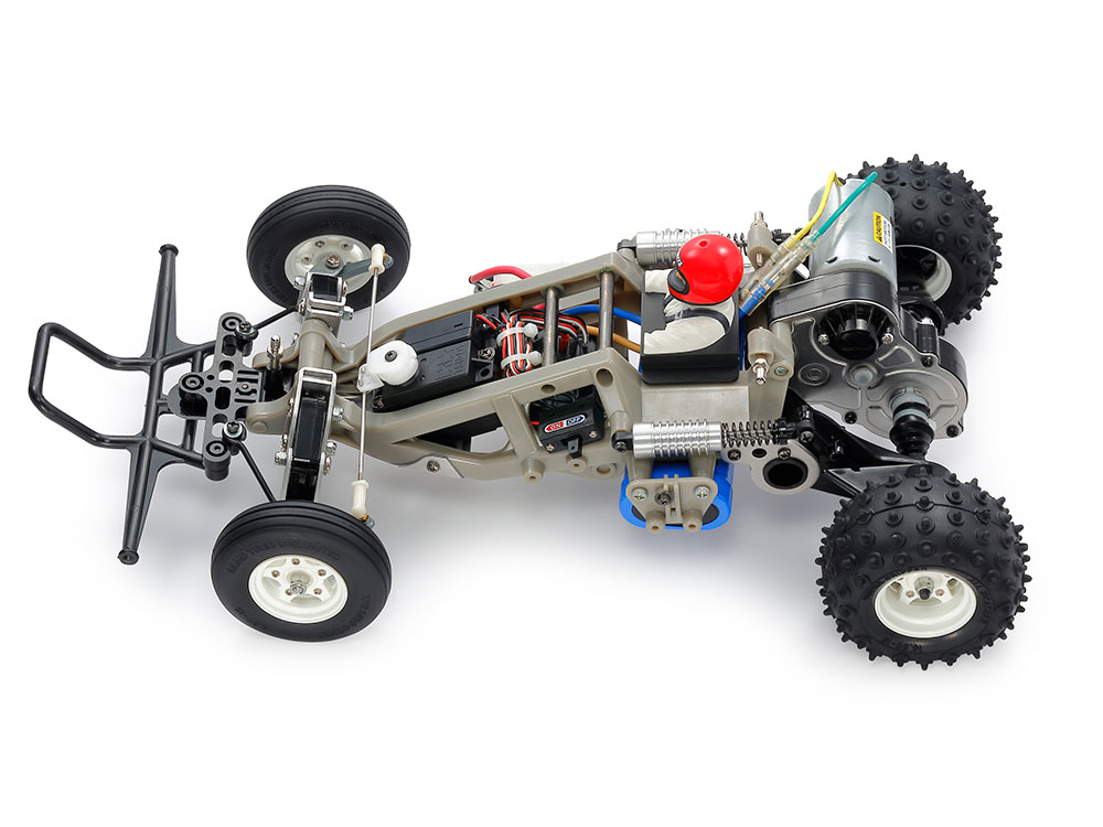 Tamiya official body-off Frog view: the space frame, inboard front springs and horizontal rear dampers are visible. Electronics illustrate a completed installation, not all supplied kit equipment.