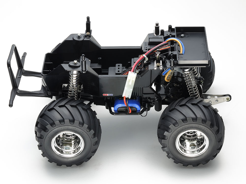 Tamiya official body-off CW-01 view: gearbox, radio installation and wheelie-bar arrangement beneath the pickup shell.