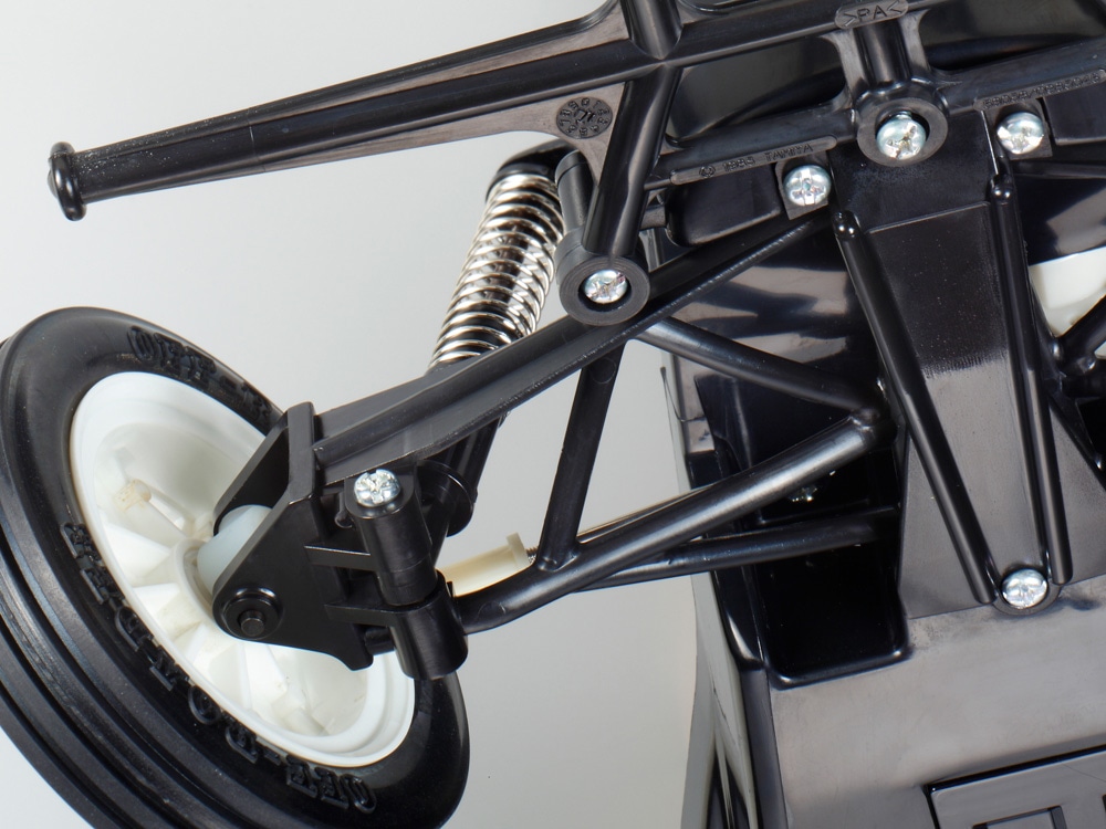 Tamiya official front-suspension detail: swing-axle hardware and friction damping in the standard Grasshopper II.