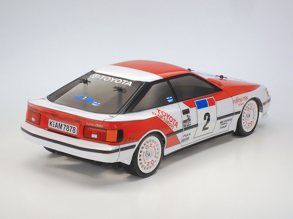 Tamiya official rear three-quarter Celica view: the ST165 livery, rear spoiler and white wheels.