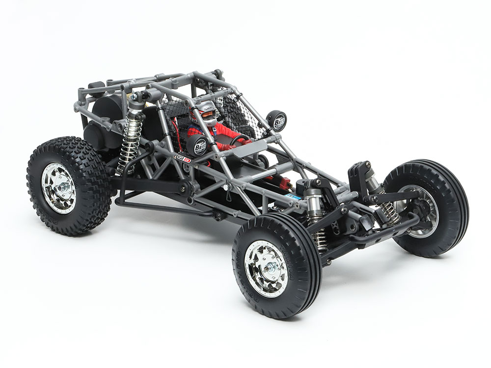 Tamiya official body-off BB-01 view: cage, suspension and electronics space. Motor, servo and ESC are completion equipment, not supplied electronics.